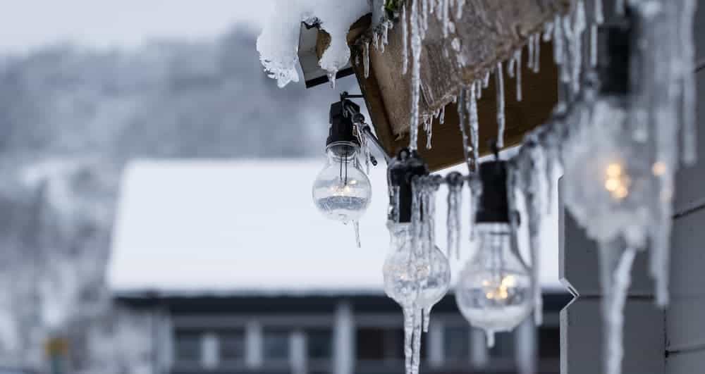 Icicles hang off of string lights on the patio