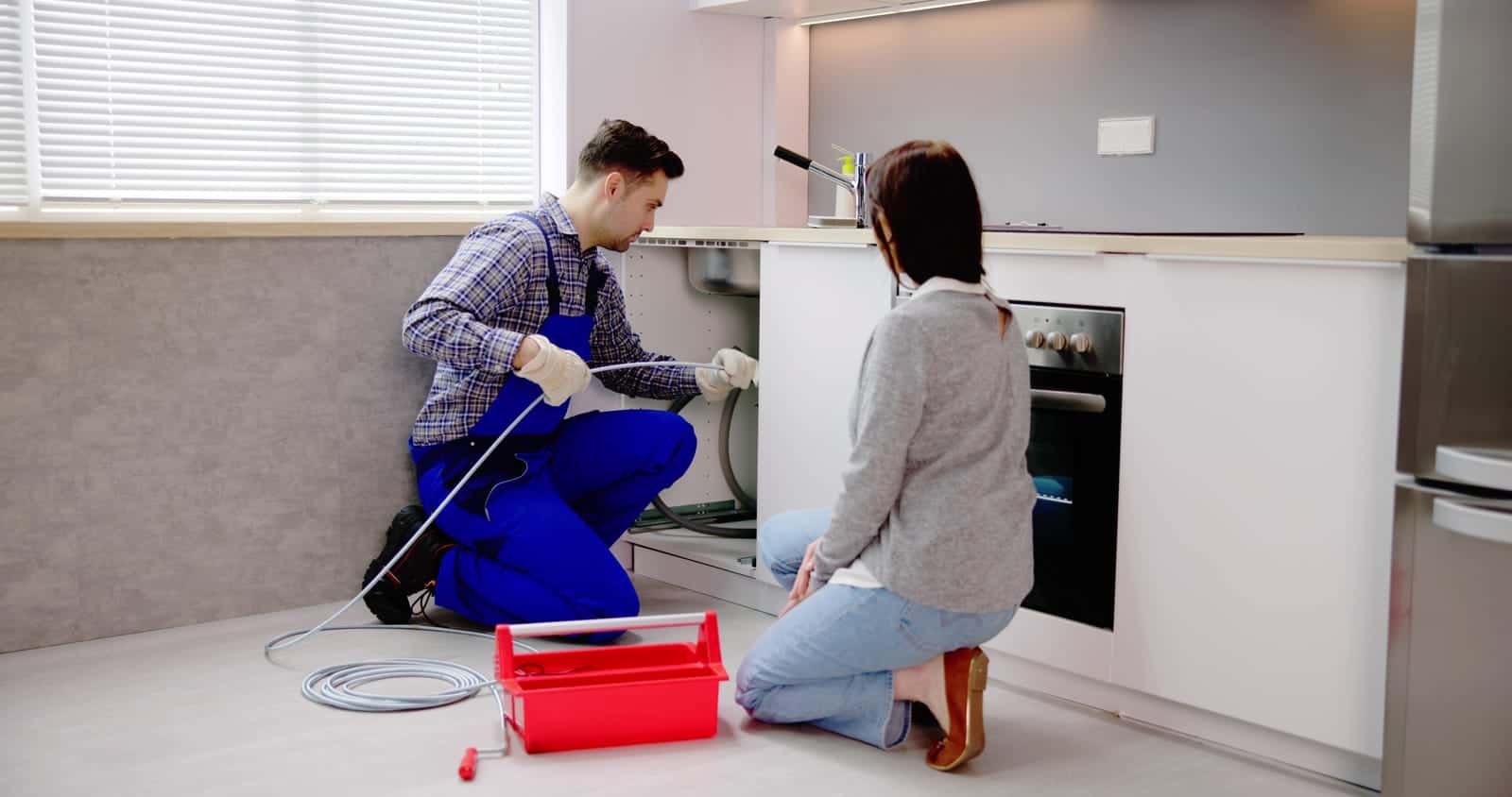 7 Critical Reasons Why Pipes Burst and When to Call the Experts 1 86657856 plumber cleaning pipe drain clog