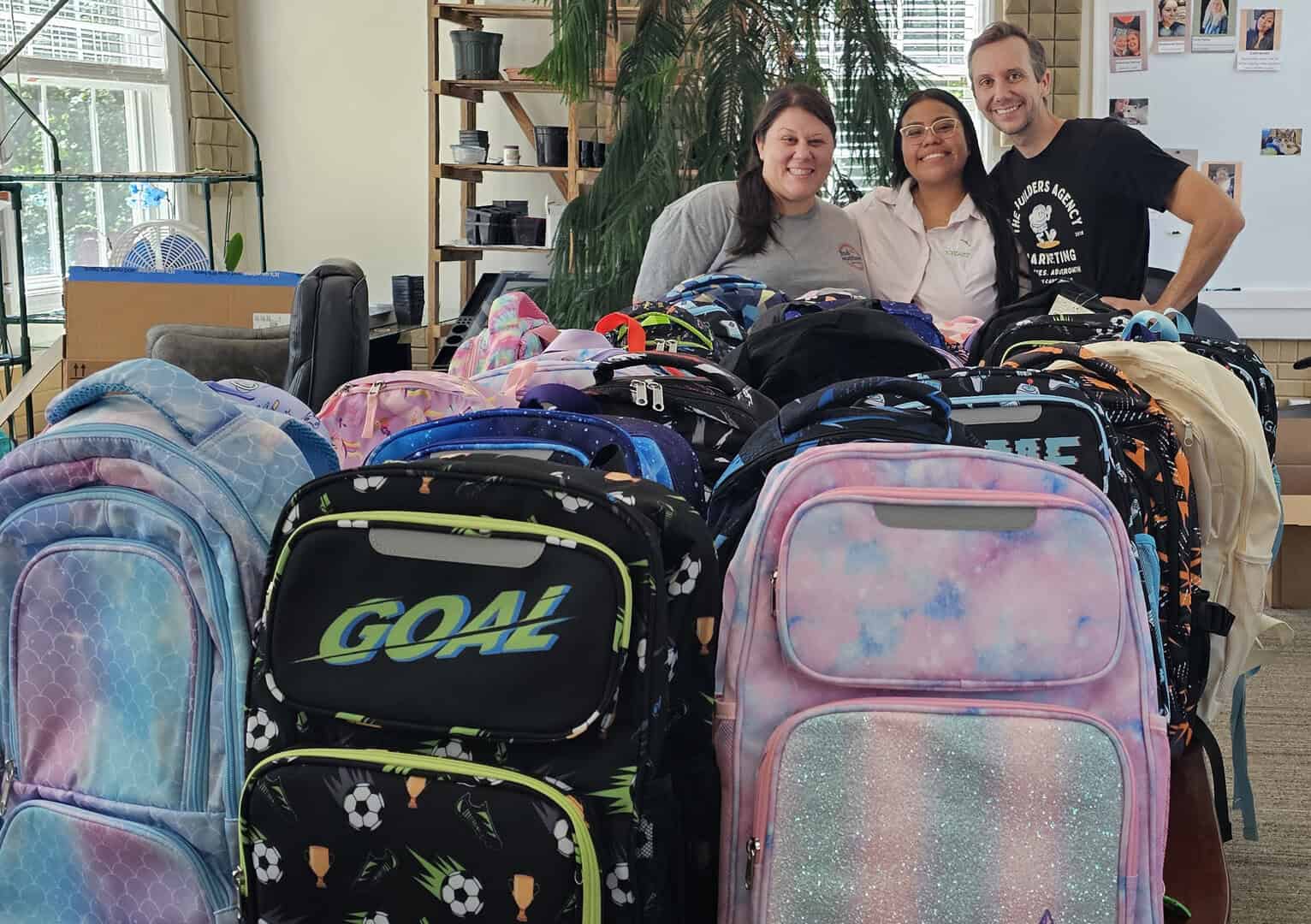 Stephanie Turco, Kathia Luna, and Matt Vidovich at the backpack drive