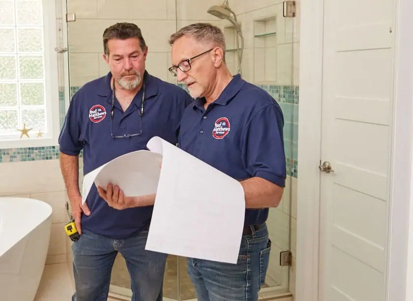 Bud Matthews Employee Fixing Bathroom